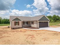 Charming single-story home with a two-car garage, lovely siding, and a well-manicured lawn at 355 Northbrook Iii School Rd # 10, Vale, NC 28164