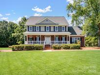 Beautiful two-story brick home with a welcoming front porch and manicured lawn at 4628 Dovefield Ln, Kannapolis, NC 28081