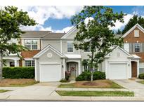 Charming townhome with a well-manicured lawn, attached garage, and inviting front entrance at 8040 Flanders St, Charlotte, NC 28277