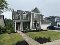 Charming two-story home with a well-manicured lawn and inviting front porch at 155 Boxelder Rd, Clover, SC 29710
