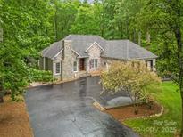Charming home with stone accents, lush landscaping, and a spacious driveway at 1669 Mary Ellen Dr, Fort Mill, SC 29708