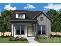 Charming home showcasing board and batten siding, stylish dormer, covered porch, and professional landscaping at 17033 Malone Ln, Mint Hill, NC 28227