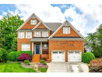 Beautiful two-story brick home with attached two-car garage and manicured landscaping at 208 Mcduffie Ln, Fort Mill, SC 29715