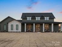 Inviting home featuring a stone facade, covered entryway, and large front yard at 2370 Bridgewater Rd, Rock Hill, SC 29730