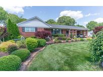 Well-maintained lawn and beautiful landscaping enhance this charming brick home's curb appeal at 3008 Imperial Dr, Gastonia, NC 28054
