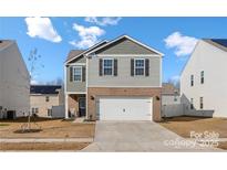 Charming two-story home with a two-car garage, landscaped front yard, and inviting curb appeal at 446 Misty Law Ln, Clover, SC 29710