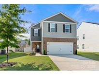 Charming two-story home featuring a two-car garage, well-maintained lawn, and inviting curb appeal at 446 Misty Law Ln, Clover, SC 29710