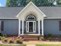 The house features a front entry with a brick landing and a covered portico with white columns at 517 Grassy Creek Run, Chester, SC 29706
