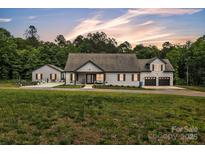 Lovely exterior view of home with a large front yard and long private driveway at 5262 Mckenzie Trl, Conover, NC 28613