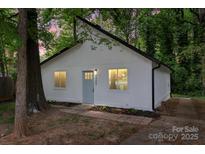 Charming home features a white exterior, black trim, and a cozy front yard at 5444 Datha Ave, Charlotte, NC 28269