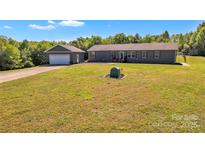 Charming single story home with detached garage and spacious green front yard at 725 Hunters Ridge Rd, Taylorsville, NC 28681
