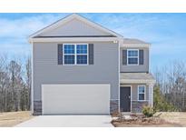 Charming two-story home with gray siding, stone accents and a two car garage at 822 N Naughton St, Chester, SC 29706