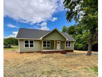 Charming single-story home with a covered porch and a well-manicured lawn in a serene neighborhood at 1050 Beaten Path Rd, China Grove, NC 28023