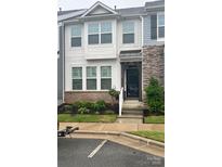 Charming townhome with manicured landscaping, brick accents, and inviting entrance with covered porch at 110 Synandra Dr # B, Mooresville, NC 28117
