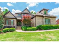 Beautiful two-story home with tan brick, manicured landscaping, and a welcoming front entrance at 1260 Rittenhouse Ln, Rock Hill, SC 29732