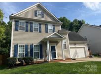 Charming two-story home with neutral siding, blue shutters, and a well-manicured lawn, creating an inviting curb appeal at 13430 Norseman Ln, Huntersville, NC 28078