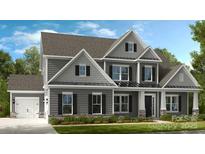 Beautiful gray home with eye-catching architectural details and manicured lawn at 18125 Sulton Terrace Dr, Huntersville, NC 28078