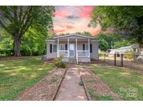 Charming single-story home featuring a covered porch, landscaped yard, and sidewalk at 205 Stowe Acres Rd, Kings Mountain, NC 28086