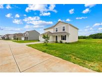 Charming two-story home featuring a well-manicured lawn with lush, green grass, plus plentiful parking spaces at 2322 Joes Lake Rd, Shelby, NC 28152