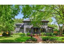 Charming two-story home with landscaped front yard and mature trees providing shade at 2329 Club Rd, Charlotte, NC 28205