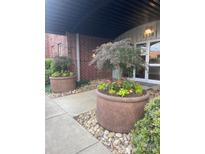 Inviting entrance with landscaped planters, stone details, and brick architecture at 2338 Yadkin Ave # D302, Charlotte, NC 28205