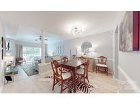Formal dining room featuring hardwood floors, modern lighting, and an elegant dining set at 2715 Selwyn Ave # 36, Charlotte, NC 28209