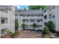 Charming condo with multiple balconies and well-manicured landscaping creating a welcoming and sophisticated entrance at 2715 Selwyn Ave # 36, Charlotte, NC 28209