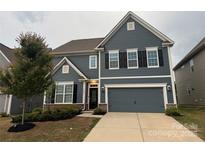 Charming two-story home with a two-car garage and manicured landscaping at 3022 Burnello Ct, Iron Station, NC 28080