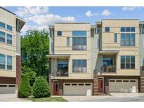 Modern townhome exterior with brick accents and a two-car garage at 411 Steel Gardens Blvd, Charlotte, NC 28205