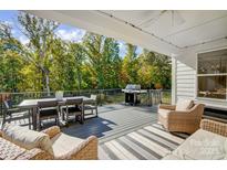 Outdoor deck with a dining table, grill, and comfortable seating, perfect for entertaining and relaxation at 4116 Spring Cove Way, Belmont, NC 28012