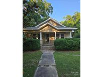 Charming one-story home with mature landscaping and inviting front porch at 412 Peachtree St, Albemarle, NC 28001