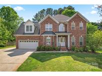 Charming two-story brick home with well-manicured lawn and attached two-car garage at 4619 Glasgow Ct, Gastonia, NC 28056