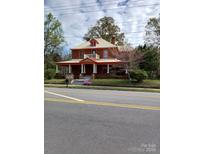 Charming brick home featuring a wide front porch, complemented by classic architectural details at 514 N Main St, Mount Gilead, NC 27306