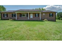 Charming single-story brick home with a well-manicured front yard and covered porch at 55 Dixie Dr, Taylorsville, NC 28681