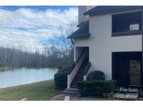 A beautiful building exterior with a well-maintained lawn and scenic water view at 5718 Dockside Dr, Charlotte, NC 28227