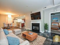 Inviting living room featuring a fireplace, TV, neutral walls and decor, and an open floor plan at 718 W Trade St, Charlotte, NC 28202