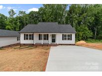 Charming single-story home featuring white siding, black shutters, a concrete driveway, and landscaped front yard at 894 Oval St, Kannapolis, NC 28081