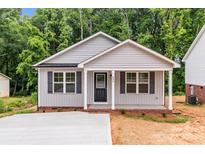 Charming single-story home featuring a covered porch and a well-manicured front yard at 896 Oval St, Kannapolis, NC 28081