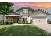 Charming single-Gathering home with a well-manicured lawn, inviting front porch, and two-car garage at 1244 Tranquil Falls Ln, Matthews, NC 28104