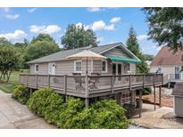 Charming home featuring a spacious deck with outdoor seating and lush landscaping at 147 Bluewing Ln # 274, Mooresville, NC 28117