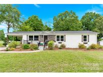 Charming single story home boasts a well-manicured lawn and covered front porch at 1501 E Church St, Cherryville, NC 28021