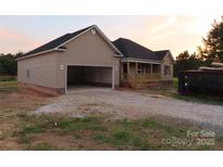 Charming new construction home featuring a spacious garage and inviting front porch at 153 Mason Tanner Ct, Rock Hill, SC 29730