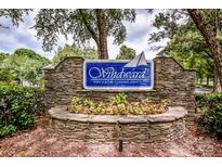Stone community sign with flower bed below and featuring 'Windward' and 'Private Community' on a blue background at 19901 Henderson Rd # M, Cornelius, NC 28031