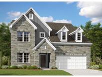 Charming two-story home featuring a stone facade, a two-car garage, and a beautifully landscaped front yard at 3040 Ballenger St, Kannapolis, NC 28027
