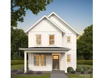 Charming two-story home featuring a welcoming front porch, white siding and black roof at 318 Sixth St, Belmont, NC 28012