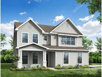 Charming two-story home with a covered front porch and landscaped yard offers great curb appeal at 3229 Bozeman Ct # 13, Stanley, NC 28164
