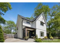 Modern farmhouse exterior with a covered porch, white siding, and well-maintained landscaping at 324 Elm St, Belmont, NC 28012