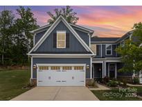 Charming two-story home with a two car garage, stone accents, and neatly manicured landscaping at 980 Prince Garrett Way, Denver, NC 28037