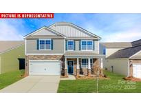 Charming two-story home featuring stone accents, a two-car garage, and a well-manicured lawn at 1340 Secrest Commons Dr, Monroe, NC 28112
