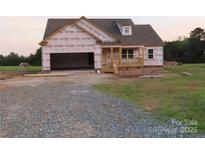 New construction home with an attached 2-car garage and materials in place for further construction at 145 Mason Tanner Ct, Rock Hill, SC 29730